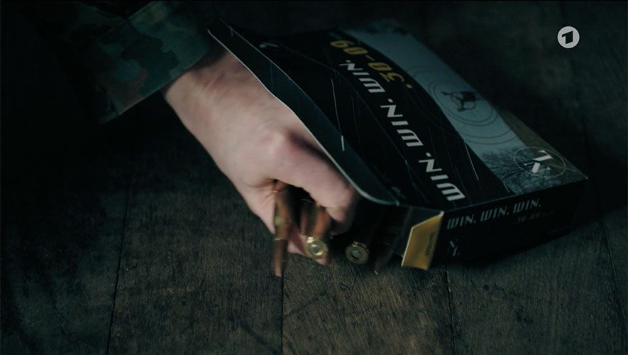 Screenshot from "Tatort Dreams" showing a package for bullet casing with a hand